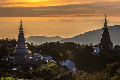 noppamethanedol and noppapol phumsiri pagoda and colorful sky at sunrise. mountains on background. doi inthanon national park, thailand.