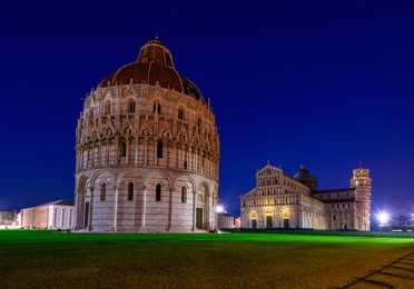 baptistery of st. john (battistero di san giovanni), cathedral (duomo di pisa) with leaning tower of pisa (torre di pisa) on piazza dei miracoli in pisa at night, tuscany, italy