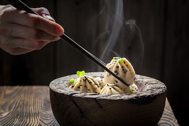 homemade and hot manti dumplings in wooden bowl