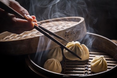 fresh and hot manti dumplings in bamboo steamer