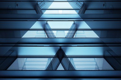 close-up photo of modern multistory building fragment with balconies and supporting beams. transparent contemporary architecture in hi-tech / minimalism style.