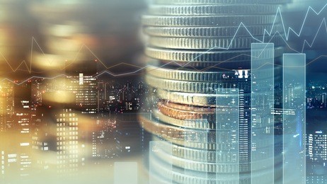double exposure of graph and rows of coins for finance and business concept