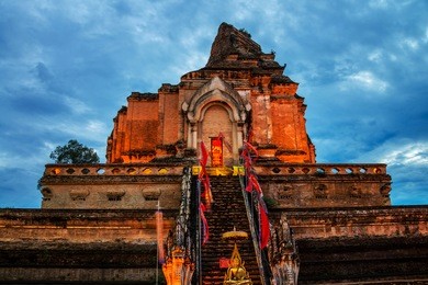 chiang mai, thailand. illuminated chedi luang pagoda at wat chedi luang temple with cloudy sky at sunset. popular landmark in chiang mai, thailand