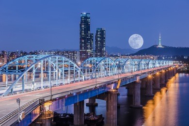 korea,seoul at night, south korea city skyline at dongjak bridge hangang river in seoul , south korea. 
background moon.