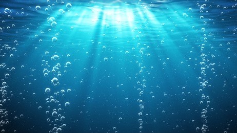 blue ocean waves from underwater with bubbles. light rays shining through. great for backgrounds.
