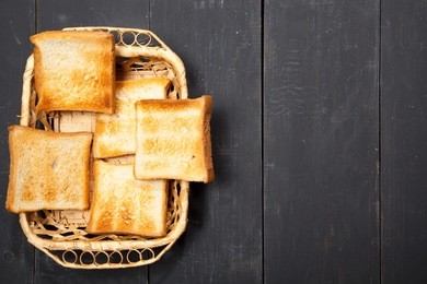 toast the bread on a black wooden background