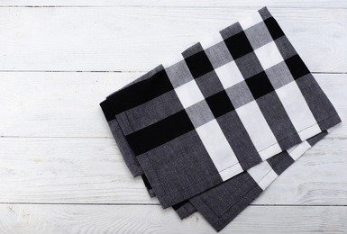 black and white napkin. the checkered tablecloth on wooden table. copy space. top view.