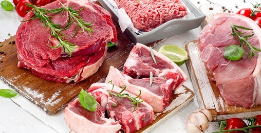 different types of raw meat with fresh herbs.
