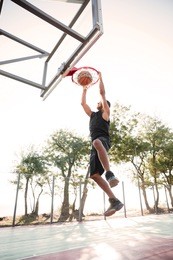 picture of basketball player practicing for basketball. looking at basketball hoop.
