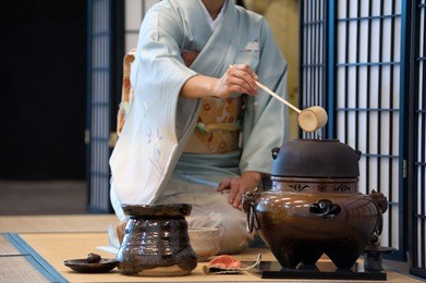 a japanese woman shows the tea ceremony during a public demonstration
