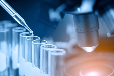 microscope with lab glassware, science laboratory research and development concept 