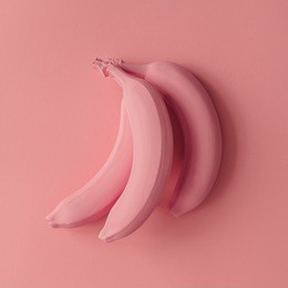 pink bananas on pink background. minimal style. flat lay.
