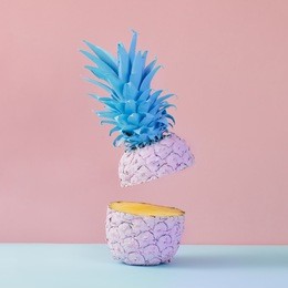 pink pineapple on yellow background. minimal style. food concept.