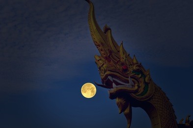 beautiful naga head sculpture and full moon night