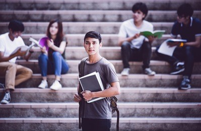 group of happy teen high school students outdoors