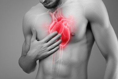 human heart, man holds his hand on his heart.