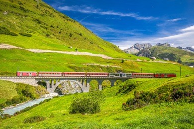 the matterhorn - gotthard - bahn on the bridge viaduct near andermatt. it is a narrow gauge railway in switzerland, europe. 