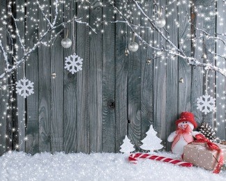 christmas interior with decorative branches, presents and candy canes on wooden planks background. new year winter composition. 