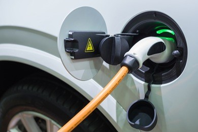 charging an electric car with the power cable supply plugged in