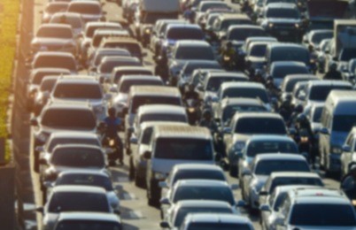 blurred traffic jam in bangkok road with sunlight.