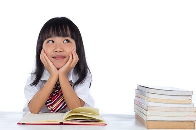 asian chinese little girl thinking while reading in isolated white background.