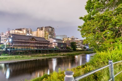 kyoto, japan. sunset view of cityscape along river.