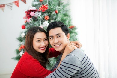 christmas asian couple.happy smiling family at home celebrating. new year people