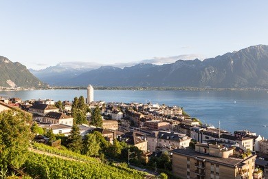 an aerial view of montreux by lake geneva in canton vaud, switzerland. the mountains at the back are the alps