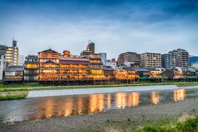 kyoto, japan. sunset view of cityscape along river.