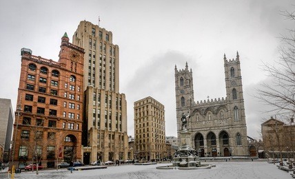 basilica of notre-dame of montreal and place d'armes on snow - montreal, quebec, canada