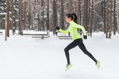 side view of active sporty young running woman runner athlete with copy space concept sport health fitness loss weight cardio training jog workout wellness.