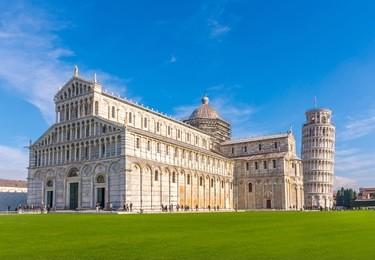 leaning tower and pisa cathedral on a bright sunny day in pisa, italy