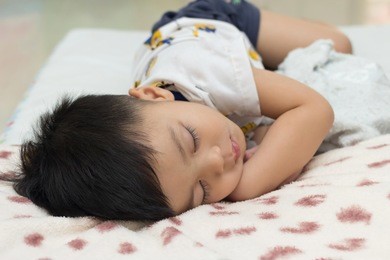 cute asian child sleep on sleeping pad.