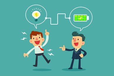 successful businessman charging battery power to another businessman's idea bulb