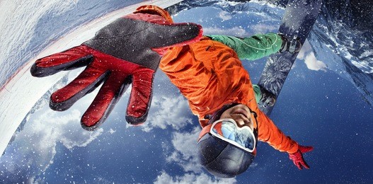 sport background. winter sport. snowboarder jumping through air with deep blue sky in background.