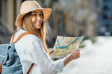 travel guide, tourism in europe, woman tourist with map on the street