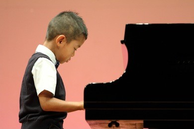 japanese boy playing a piano (first grade at elementary school)