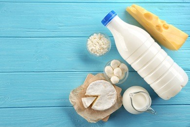 dairy products on wooden background, top view