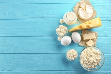 dairy products on wooden background, top view