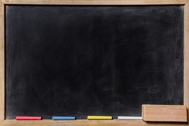 blackboard with colored chalks and eraser horizontal composition