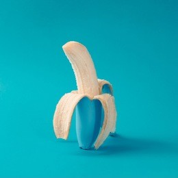 painted blue peeled banana. minimal concept.