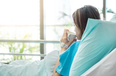 illness asia patient women and hospital concept - illness asian patient women on bed seeing windows in room alone of hospital and copyspace