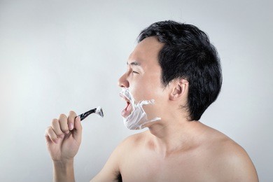 asian man is shaving