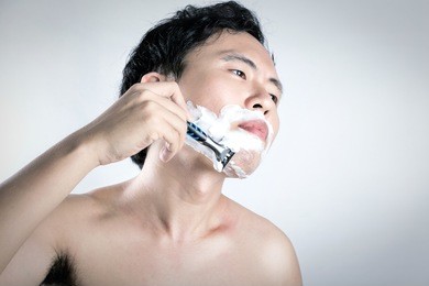 asian man is shaving