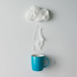 cup of coffee with steam and cloud made of cotton wool . flat lay. weather concept
