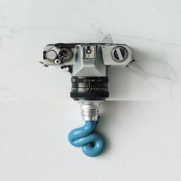 collage made out of vintage camera and paint tube. flat lay. minimal concept.
