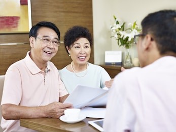 senior asian couple listen to explanation by a sales representative, happy and smiling.