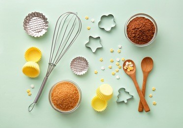 dessert ingredients and utensils on green pastel background. top view