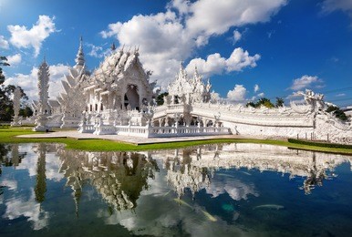 wat rong khun the white temple and pond with fish, in chiang rai, thailand
