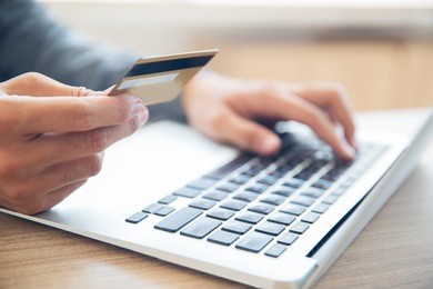 man making online purchase with credit card